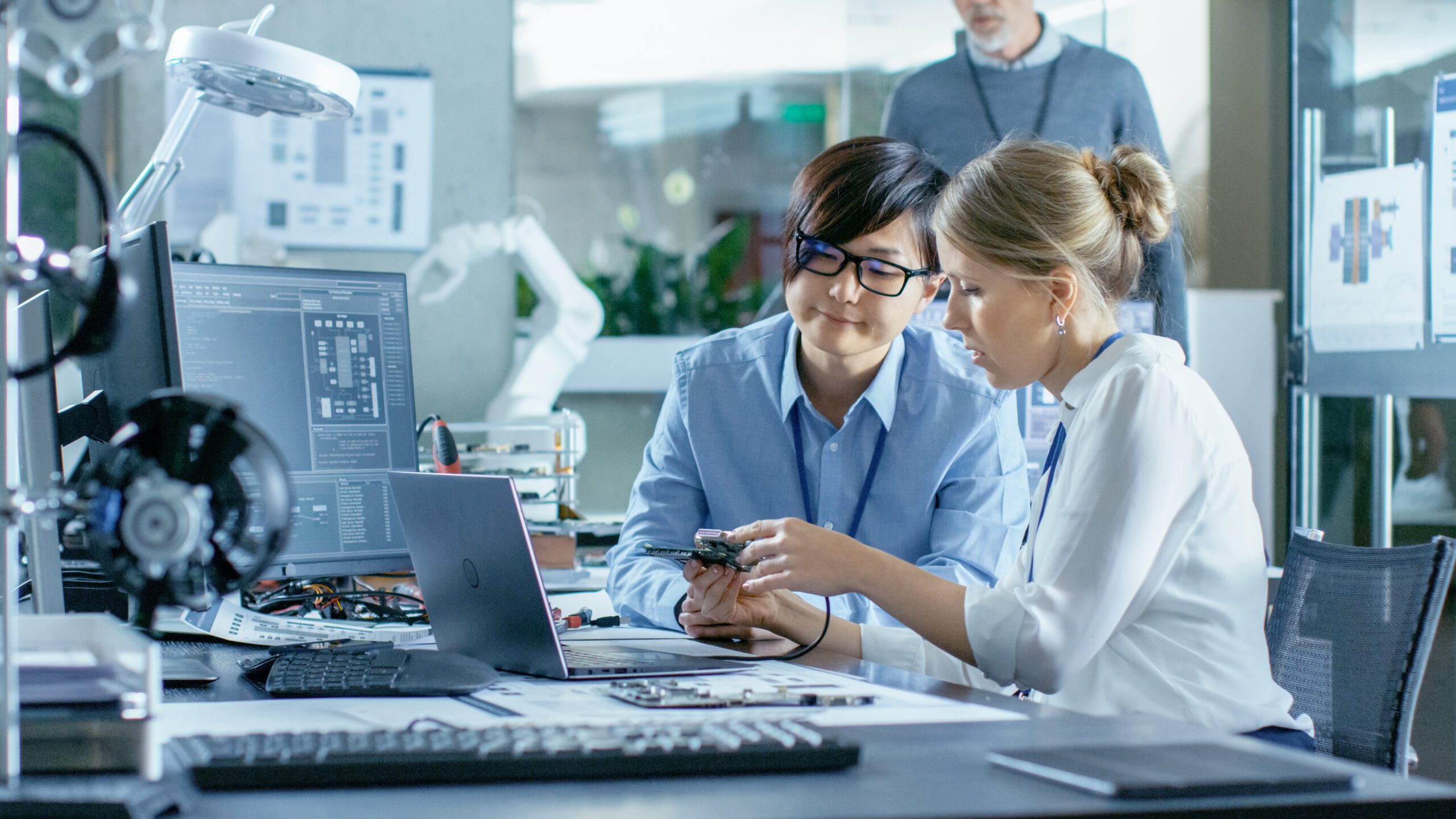 Image, Asian Scientist Sitting at His Desk Consults Engineer They Conne